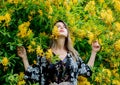 Style woman near yellow flowers in a grarden Royalty Free Stock Photo