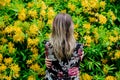 Style woman near yellow flowers in a grarden Royalty Free Stock Photo