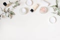 Styled beauty frame, web banner. Skin cream, shampoo bottle, dry eucalyptus leaves and pink Himalayan salt. White table