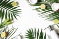 Styled beauty frame, web banner. Skin cream, soap bottle, coconut, lemons and lime fruit on lush palm leaves. White