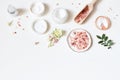 Styled beauty frame, web banner. Skin cream, tonicum bottle, dry flowers, leaves, rose and Himalayan salt. White table