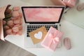 Styled feminine desk workspace with pink tulips, laptop computer and envelope. Top view notebook screen. Pink gift box and pink Royalty Free Stock Photo