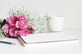 Styled stock photo. Closeup of wedding bouquet made of pink roses and baby`s breath, Gypsophila flowers lying on white Royalty Free Stock Photo