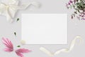 Styled stock photo. Feminine wedding desktop mockup. White roses, satin ribbon, beads on delicate beige background. Copy space. To Royalty Free Stock Photo