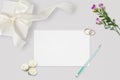 Styled stock photo. Feminine wedding desktop mockup. White roses, satin ribbon, beads on pastel gray background. Copy space. Top v Royalty Free Stock Photo