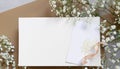 Styled stock photo. Feminine wedding desktop stationery mockup with blank greeting card, baby`s breath Gypsophila Royalty Free Stock Photo
