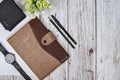 Styled tabletop, whitewood workspace, brown notebook and office objects, work desk top view with work utensils