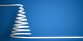 Styled white ribbon serpentine christmas tree on blue background with copy space