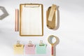 Styled working space with gold office supplies and color sticky note