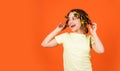 Styling tips. Small girl Curling Hair Using Curlers orange background. Adorable child hairdo. Teen hobbies. Daughter Royalty Free Stock Photo