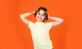 Styling tips. Small girl Curling Hair Using Curlers orange background. Daughter with curlers on her head laughing Royalty Free Stock Photo