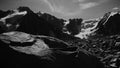 Stylised in an old archived style footage view of mountains with glaciers. 4K bw video with noise and scratches effects