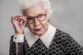 Stylish adult female looking from over her eyeglasses Royalty Free Stock Photo