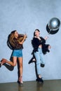 stylish african american girl with smartphone photographing asian friend having fun with balloon Royalty Free Stock Photo