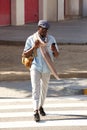 Stylish African American man walking outdoors with smart phone Royalty Free Stock Photo