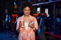 stylish african american woman holding cup