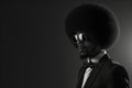 A Stylish Africanamerican Gentleman Flaunting His Impressive Afro With Confidence