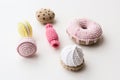 Stylish amigurumi toy sweets. Knitted cakes, candies and donuts on white background