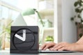 Stylish analog clock on table in office