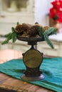 Stylish antique decor with pine cones. A handful of pine cones on an antique bronze scale