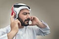 Stylish Arabian man in headphones, Arabian guy listening to music