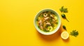 Stylish Asian-inspired Fish And Lemon Soup On Yellow Background