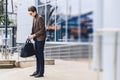 stylish traveller in jacket with passport and tickets in urban c Royalty Free Stock Photo