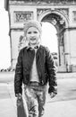 Girl near Arc de Triomphe in Paris, France going forward