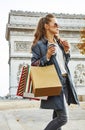 Fashion-monger with shopping bags having coffee and macaroon Royalty Free Stock Photo