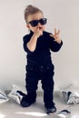 Stylish baby boy in black rocker clothes and sunglasses Royalty Free Stock Photo