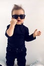 Stylish baby boy in black rocker clothes and sunglasses Royalty Free Stock Photo