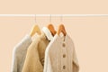 Stylish baby clothes hanging on rack against color background Royalty Free Stock Photo