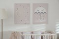 Stylish baby room with crib and cute wall art