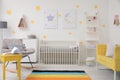 Baby room interior with crib, rocking chair and sofa Royalty Free Stock Photo