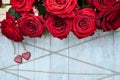 Stylish background on the theme of love, red roses , wooden hearts and twine, space for text, mockup