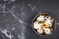 Stylish background, white eggs decorated with golden foil in rustic bowl on black marble background. Easter concept. Royalty Free Stock Photo