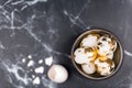 Stylish background, white eggs decorated with golden foil in rustic bowl on black marble background. Easter concept. Royalty Free Stock Photo
