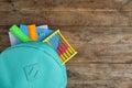 Stylish backpack with different school stationary on wooden table, top view Royalty Free Stock Photo