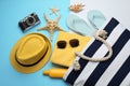 Stylish bag with beach accessories on color background, flat lay Royalty Free Stock Photo