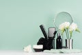 Stylish bathroom interior with black accessories on mint menthe wall, white table - mirror, towel, soap, sponge, brush, toothbrush Royalty Free Stock Photo