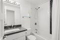 Stylish bathroom interior with dark grey countertop fitted with white porcelain sink
