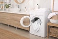 Stylish bathroom interior with modern washing machine Royalty Free Stock Photo