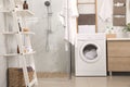 Stylish bathroom interior with washing machine Royalty Free Stock Photo