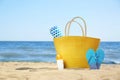 Stylish beach accessories on sand near sea Royalty Free Stock Photo