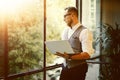 Stylish Bearded Businessman Wearing Glasses White Shirt Waistcoat Holding Modern Laptop Hands Looking Panoramic Window Royalty Free Stock Photo