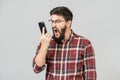 Stylish bearded man with dark hair angry shouting on the phone Royalty Free Stock Photo