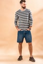 Stylish bearded man posing in striped sweatshirt Royalty Free Stock Photo