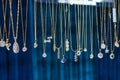 Stylish beautiful bijouterie hanging on the stand in the accessories store. Various Jewelry bijouterie show in retail shop window Royalty Free Stock Photo