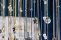 Stylish beautiful bijouterie hanging on the stand in the accessories store. Various Jewelry bijouterie show in retail shop window Royalty Free Stock Photo