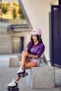 Stylish beautiful girl fit her knee during rollerblading Royalty Free Stock Photo